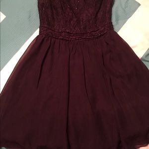 A dark purple, above the knee formal dress